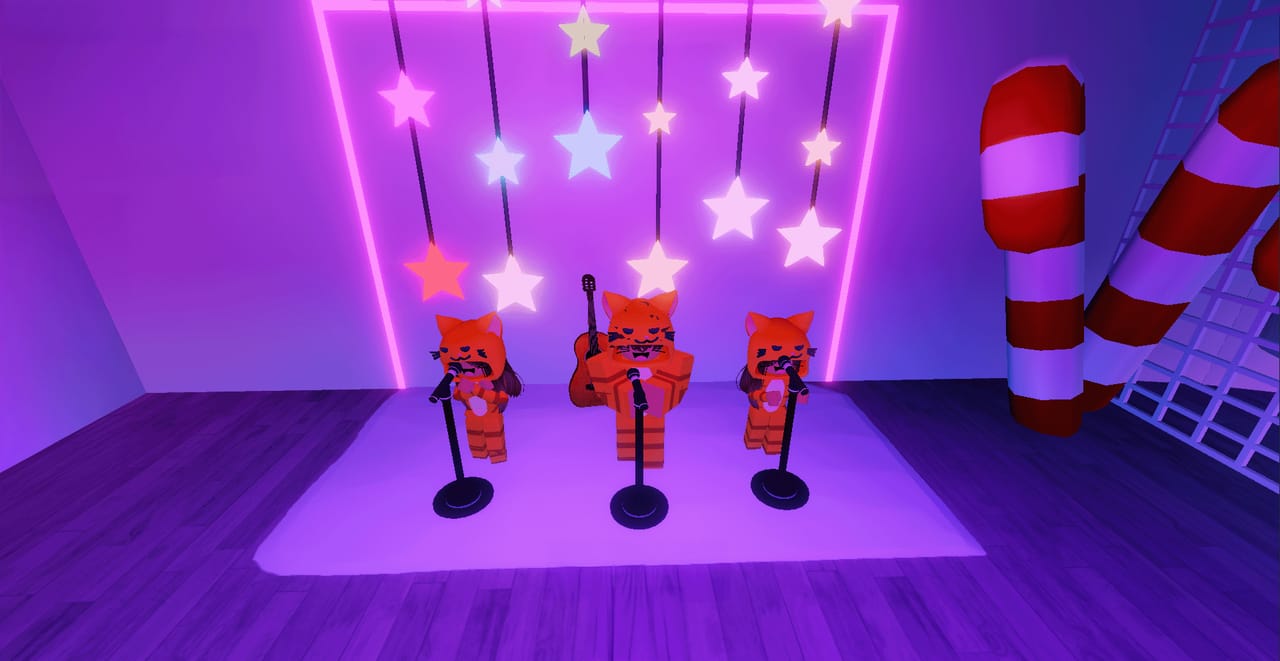 Andr&eacute;s and his family as game avatars performing on a neon-lit stage, off the clock.